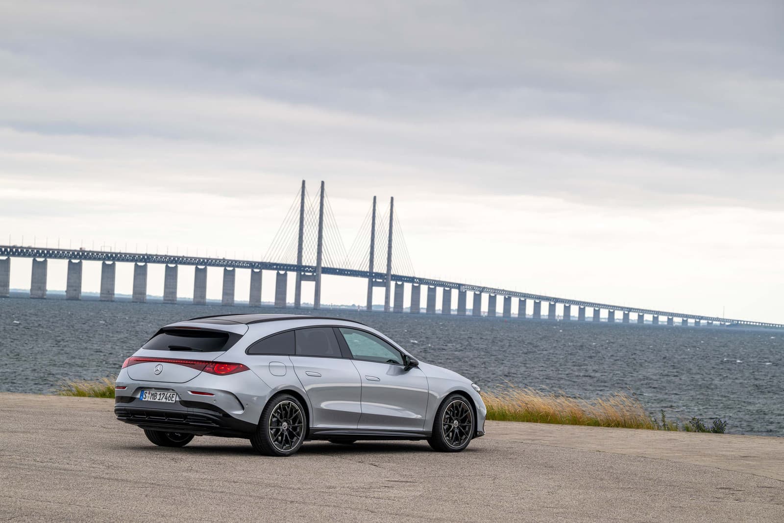 Silver Mercedes CLA Shooting Brake seen from the rear three-quarter by the sea